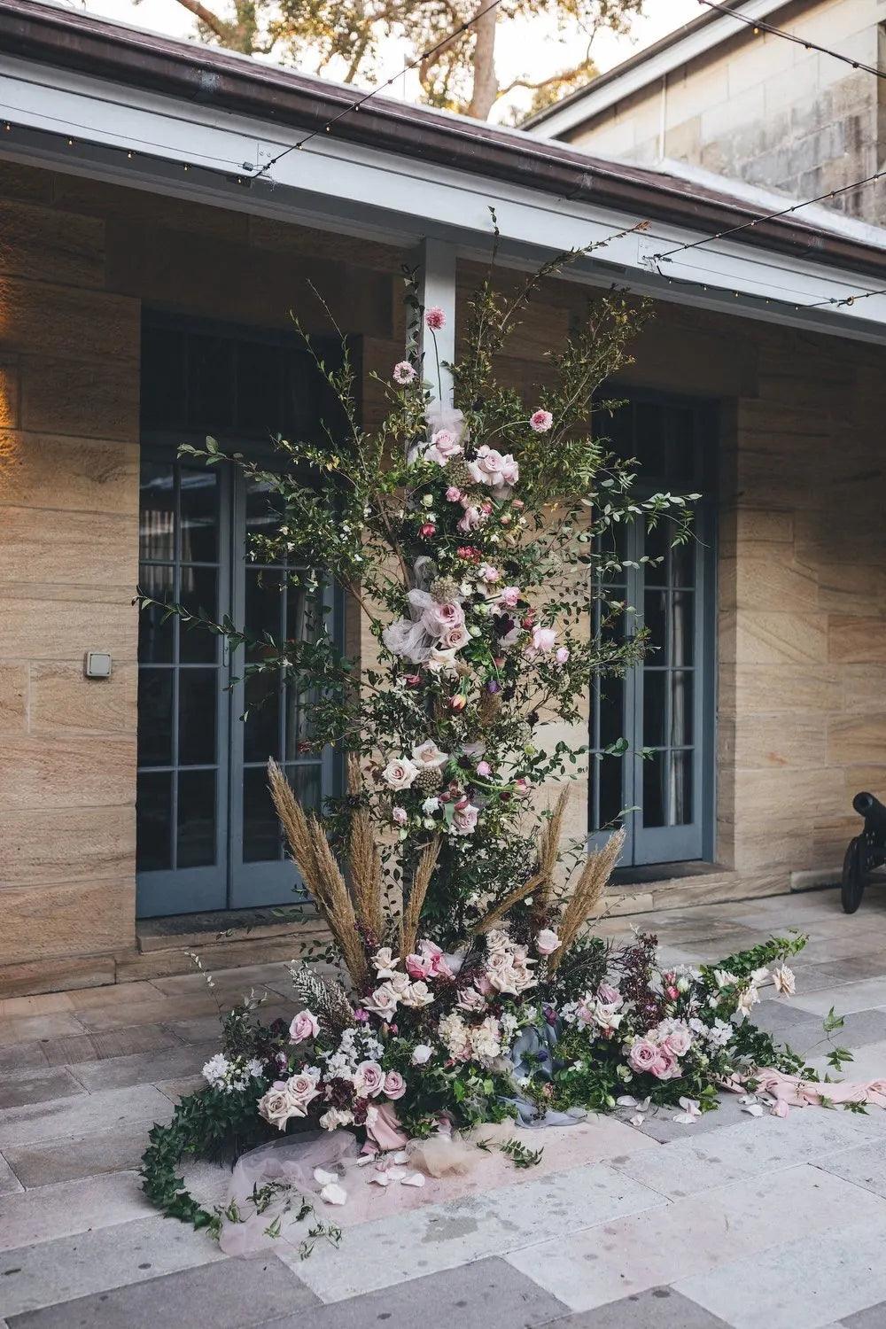 Floral installation climbing the centre pole in the Sandstone Courtyard at Gunners Barracks, by Lime Tree Bower Florist