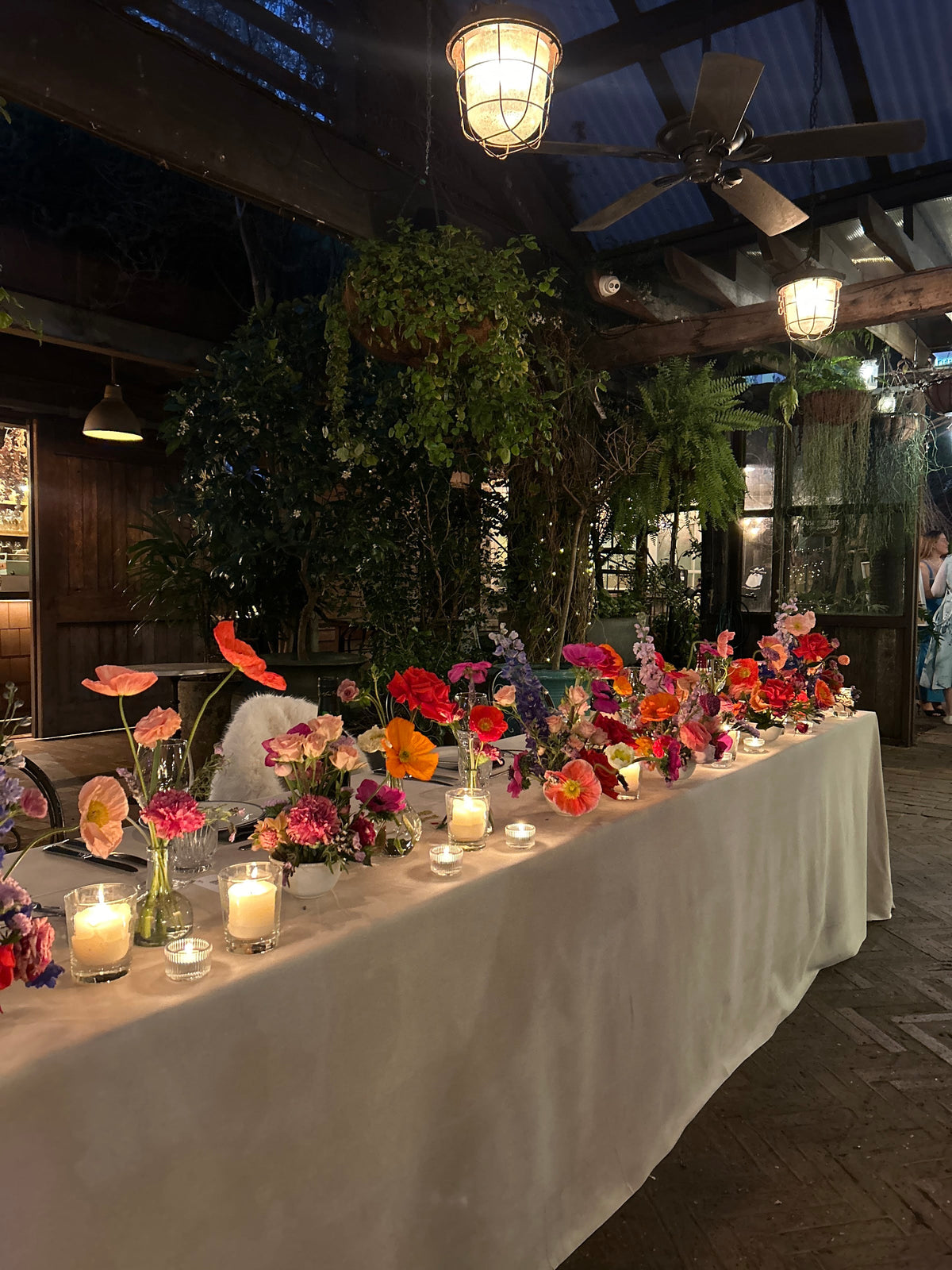 Long tables lit by candles in The Garden at The Grounds of Alexandria