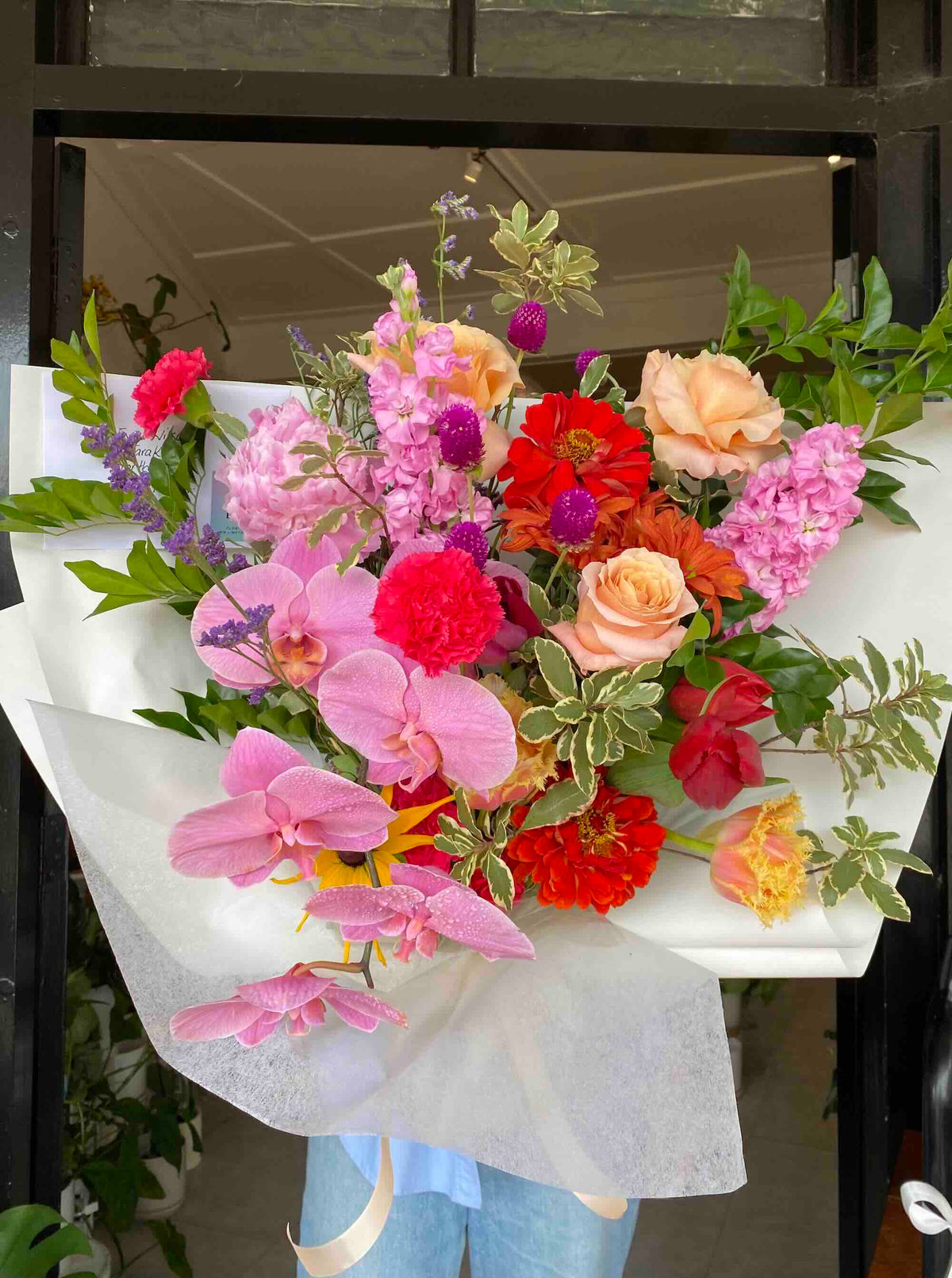bright colourful mothers day bouquet flowers wrapped with orchid