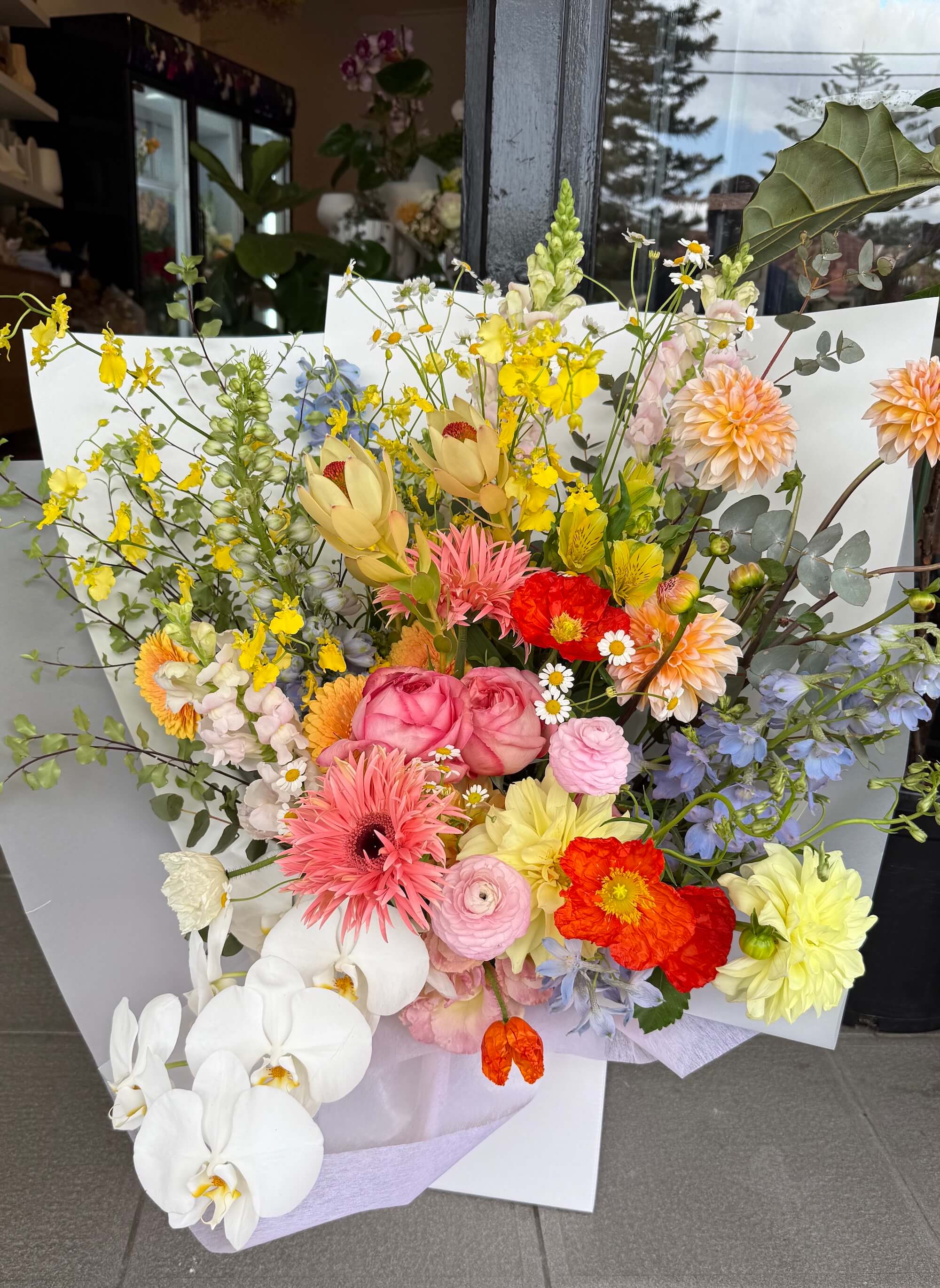 gorgeous fresh flowers wrapped in a bouquet with orchid, natives and roses