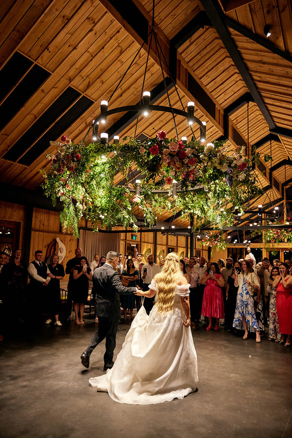 couple on dance floor at bendooley book barn wedding underneath ceiling flowers