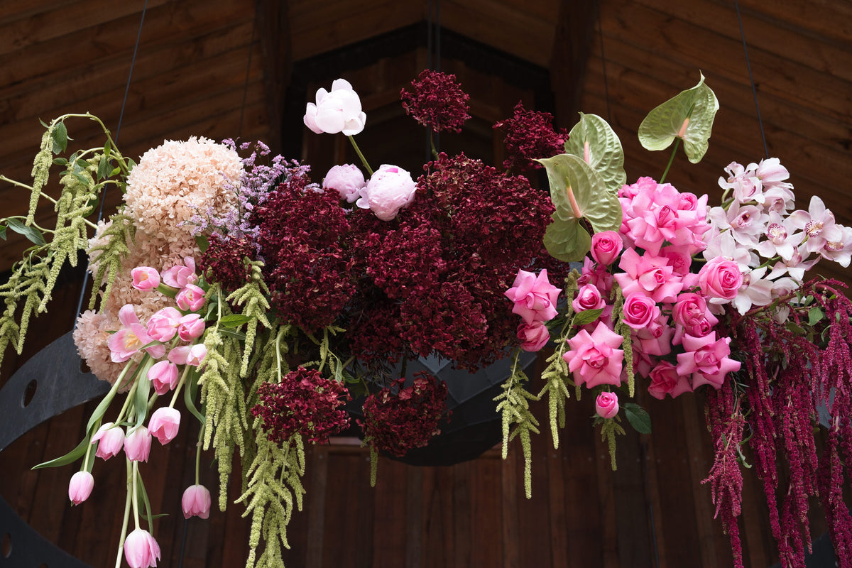 Close-up of the hanging hoop florals in dusty pink, burgundy and green