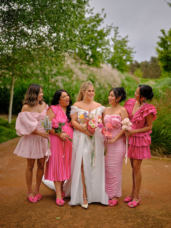 bride with bridesmaids in pink dresses with whimsical flowers