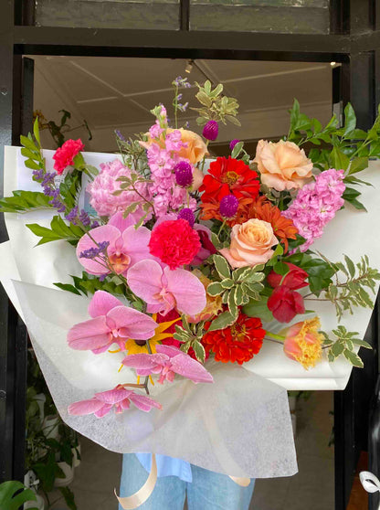 bright colourful mothers day bouquet flowers wrapped with orchid