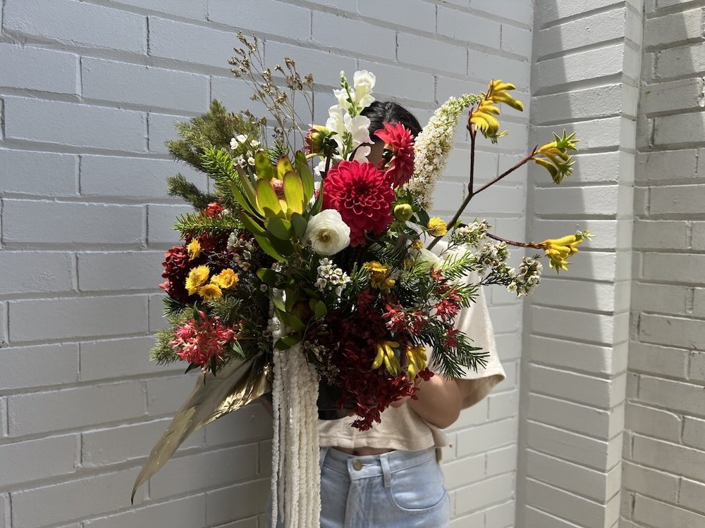 textured christmas flowers table arrangement large with red yellow green white flowers