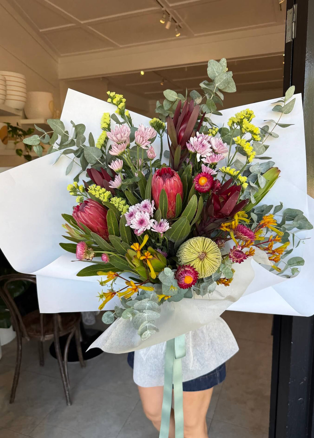 bouquete of native australian mothers day flowers with red protea statice leucadendrons and banksia paper daisy sydney delivery