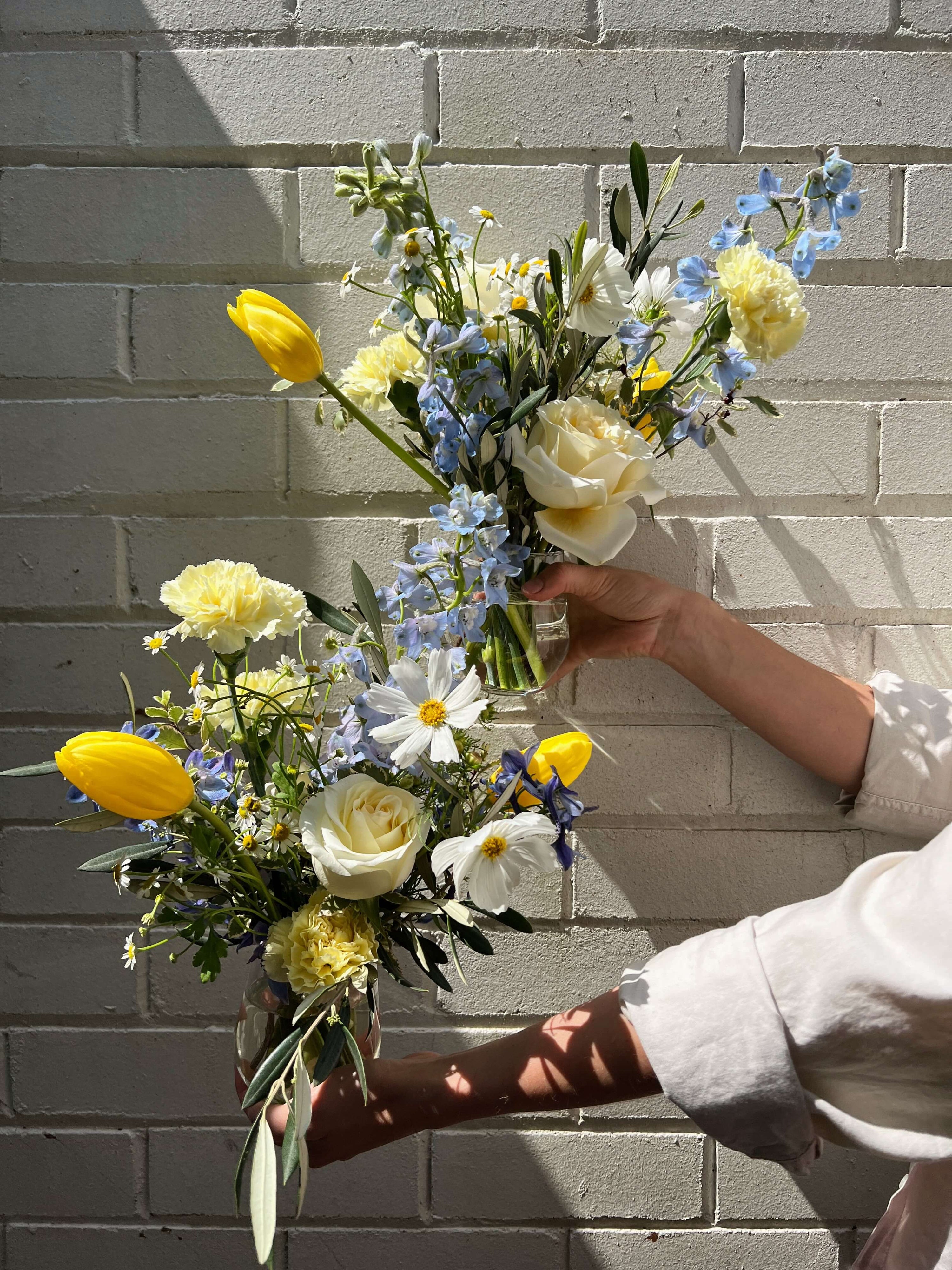 blue yellow flower arrangement in vase